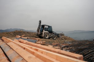 a tractor is parked on top of a pile of wood