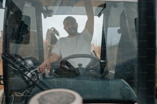 a man sitting in the driver's seat of a tractor