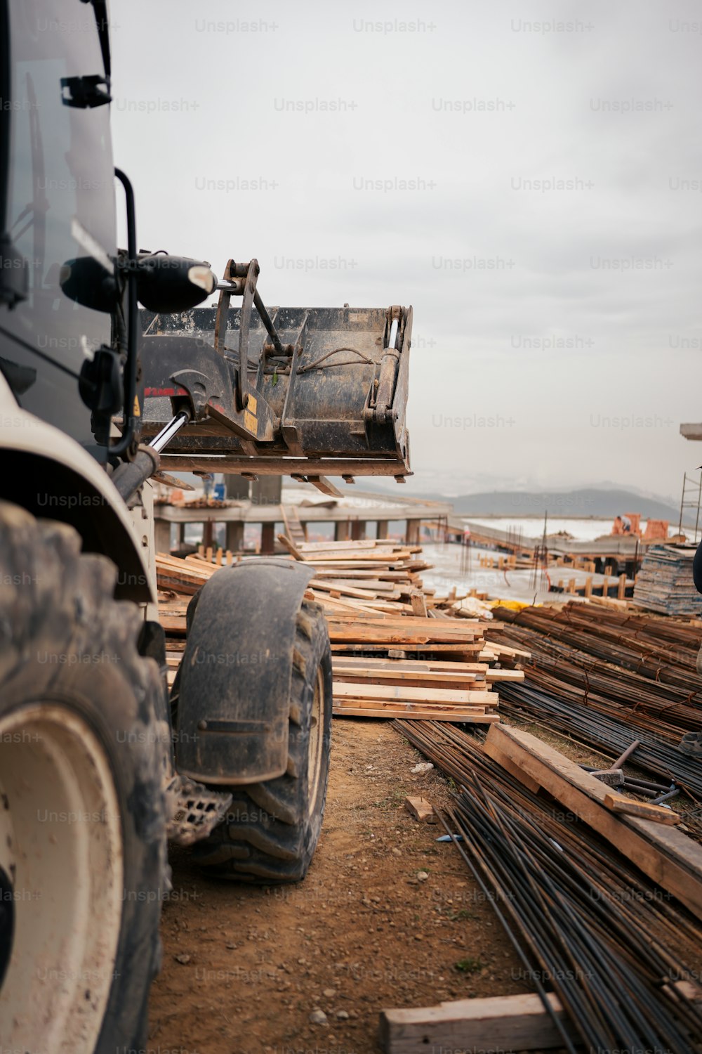 a large truck parked next to a pile of wood