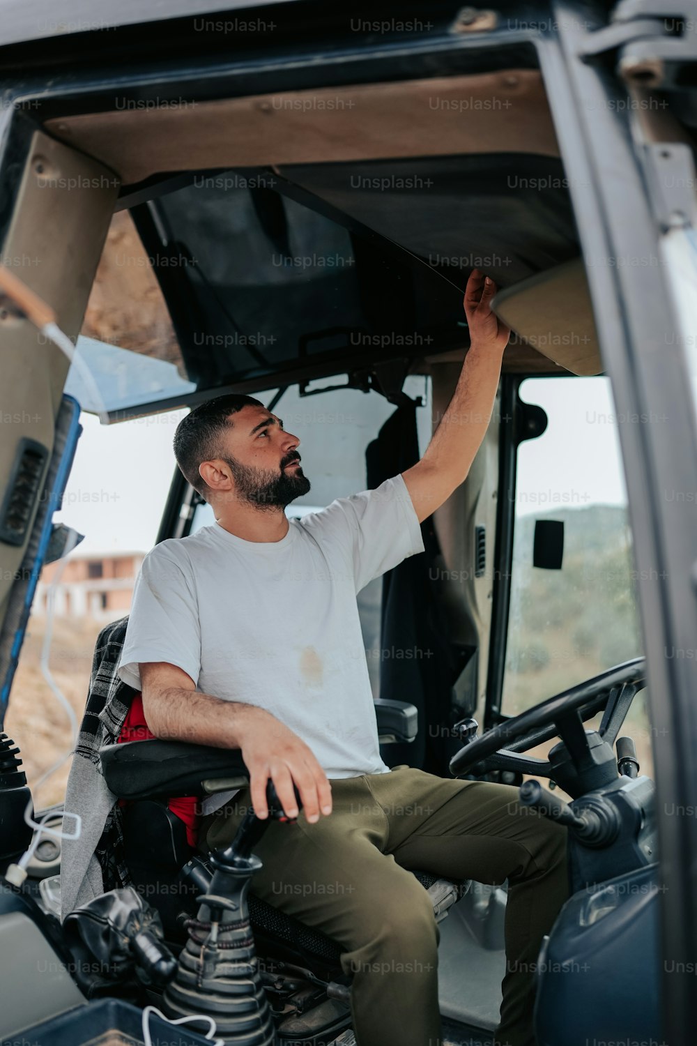 a man sitting in the driver's seat of a truck