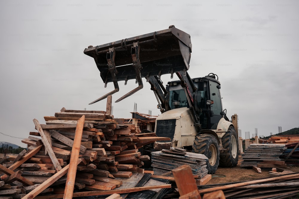 a bulldozer is parked in a pile of wood