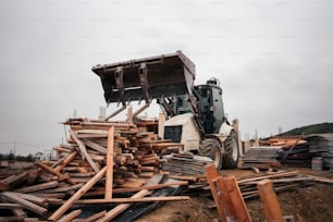 a bulldozer moving through a pile of wood