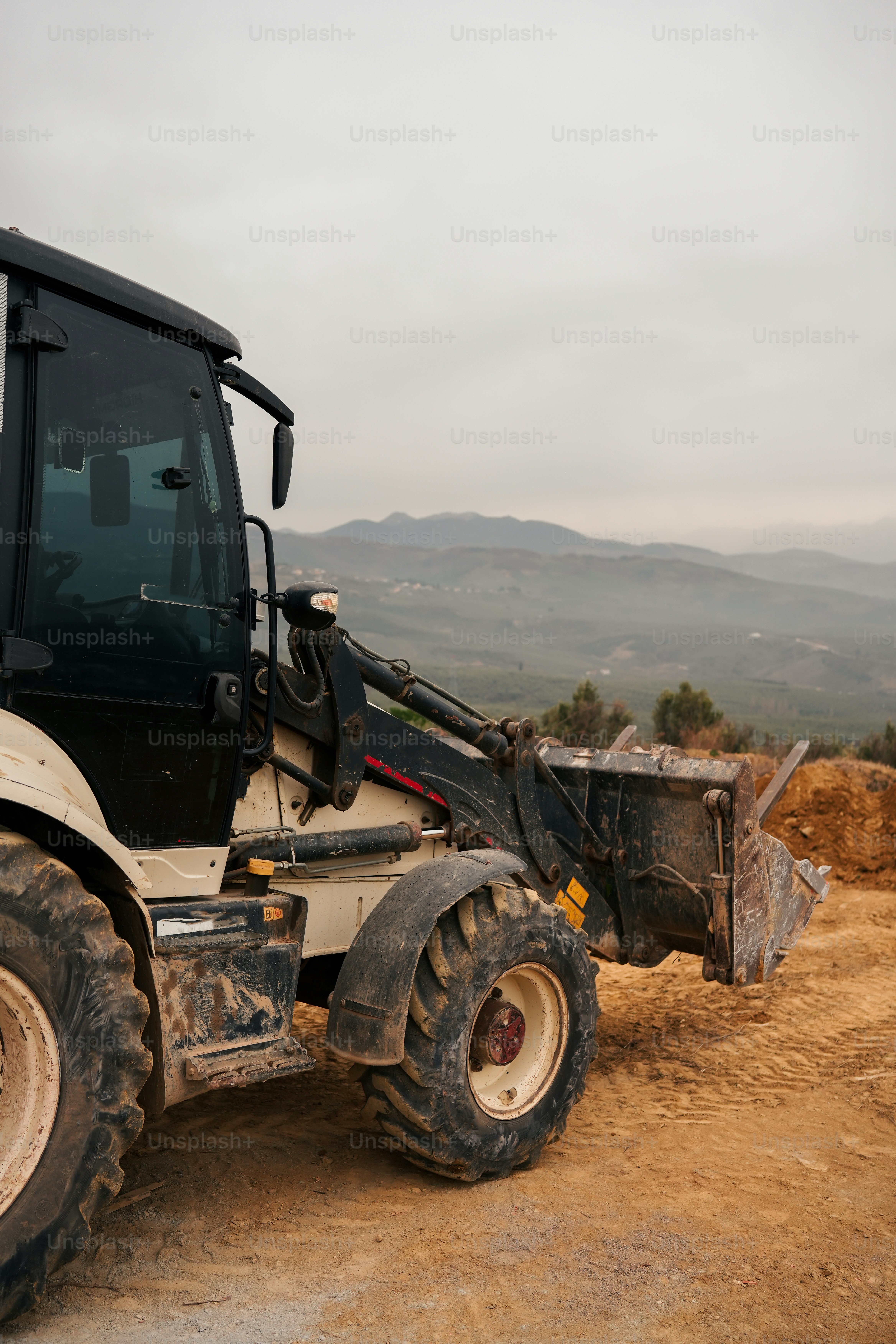 a tractor is parked on a dirt road