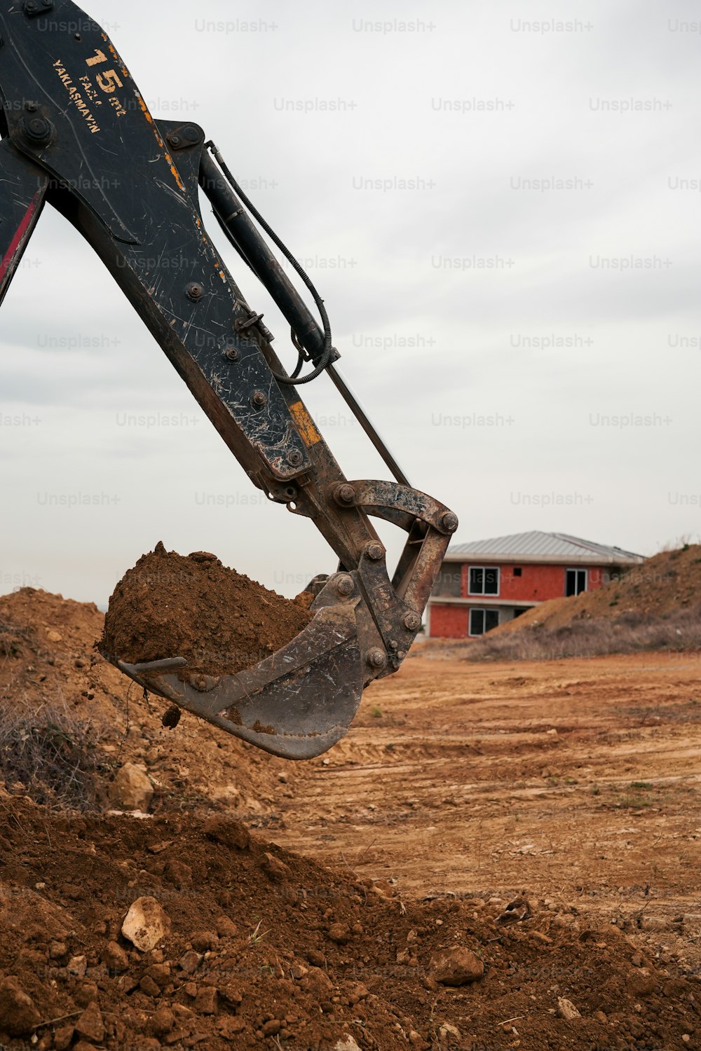 a bulldozer digging dirt in front of a building