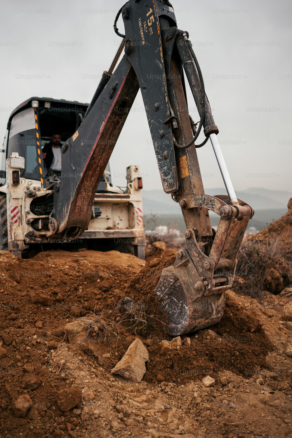 an excavator digging dirt in a field