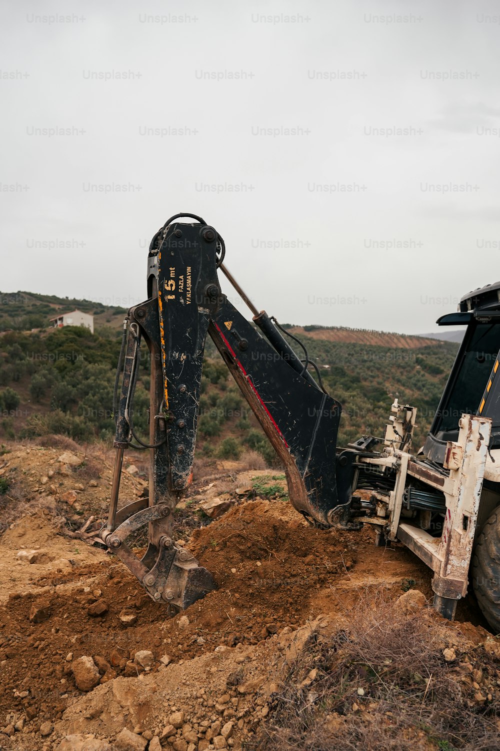Una excavadora cavando a través de un campo de tierra