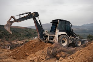 a bulldozer digging dirt on a hill side