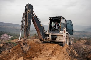 a bulldozer digging dirt on a dirt road