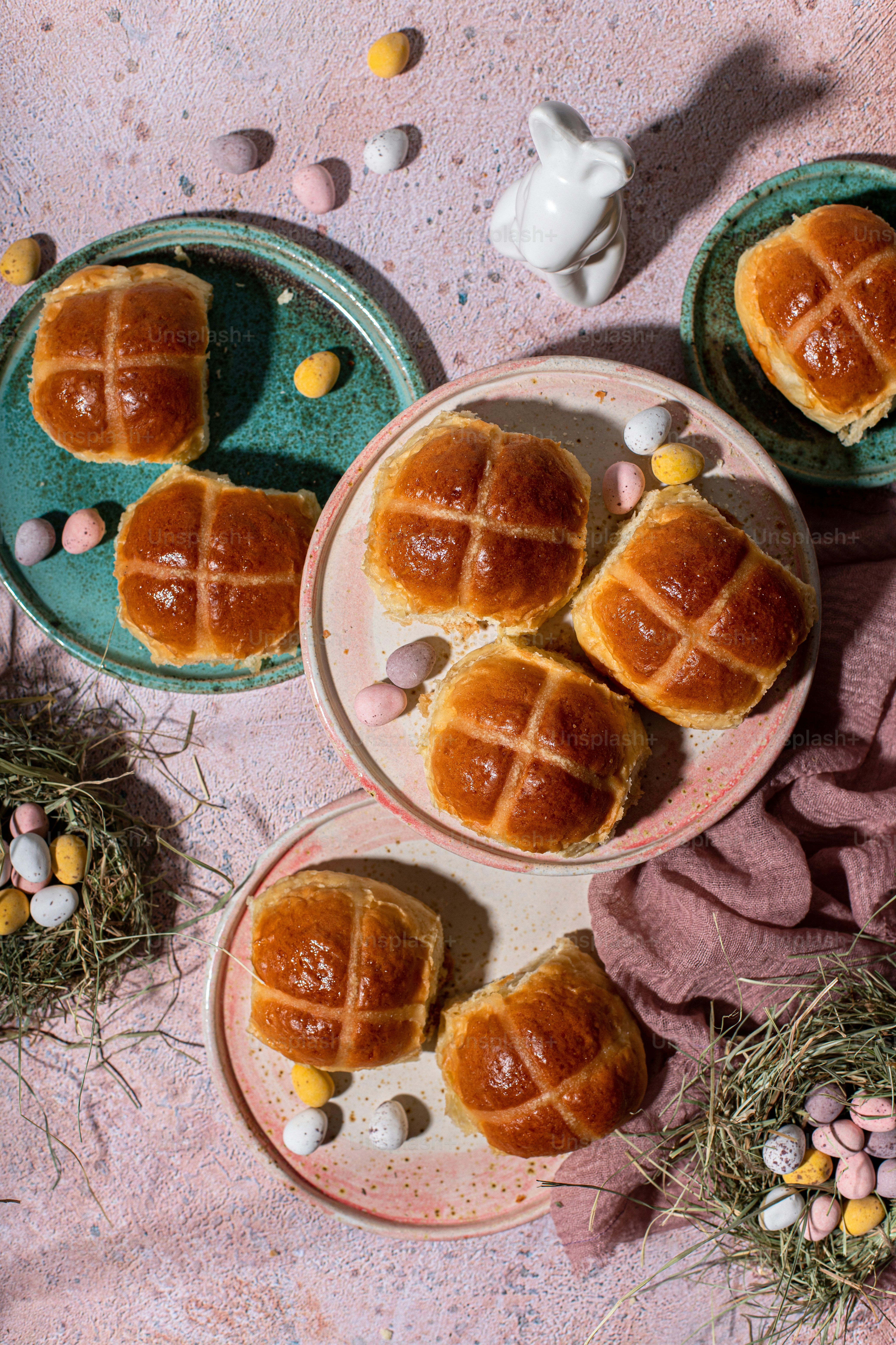 a table topped with plates filled with buns