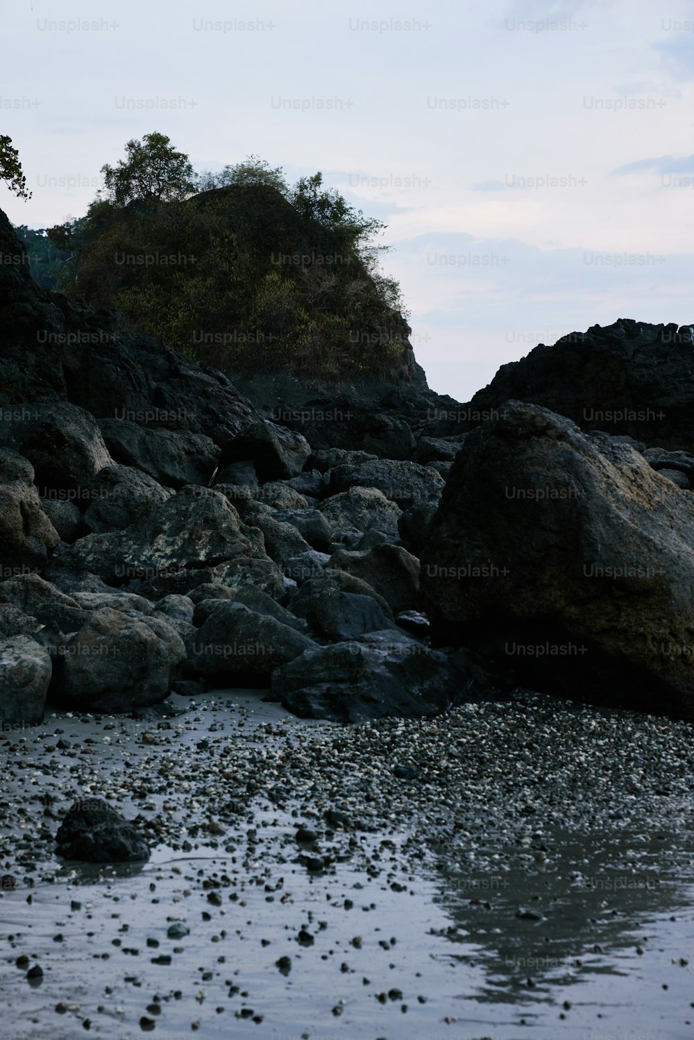 a rocky beach area with rocks and water