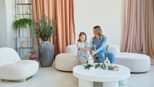 a mother and daughter sitting in a living room