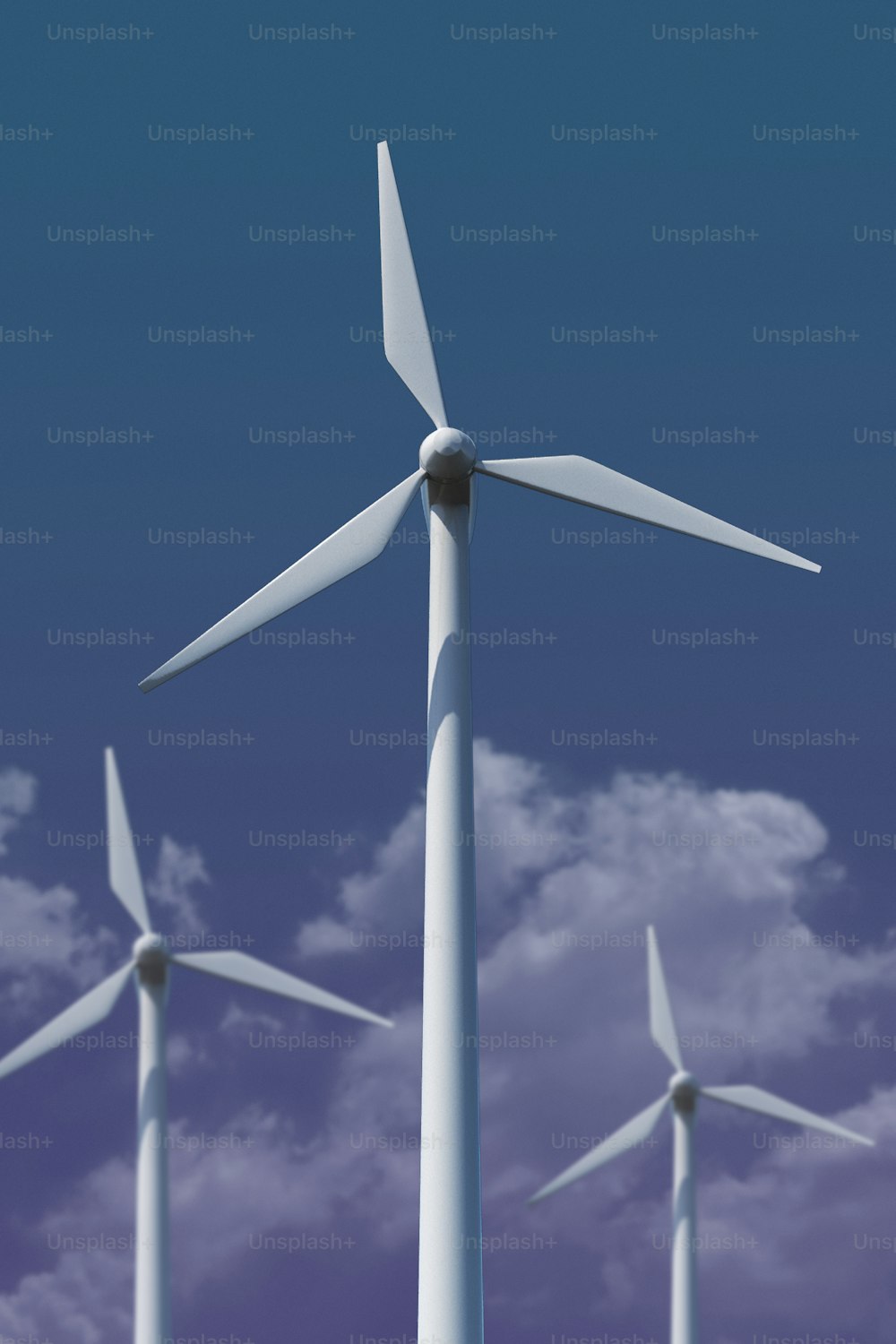 a group of wind turbines against a blue sky