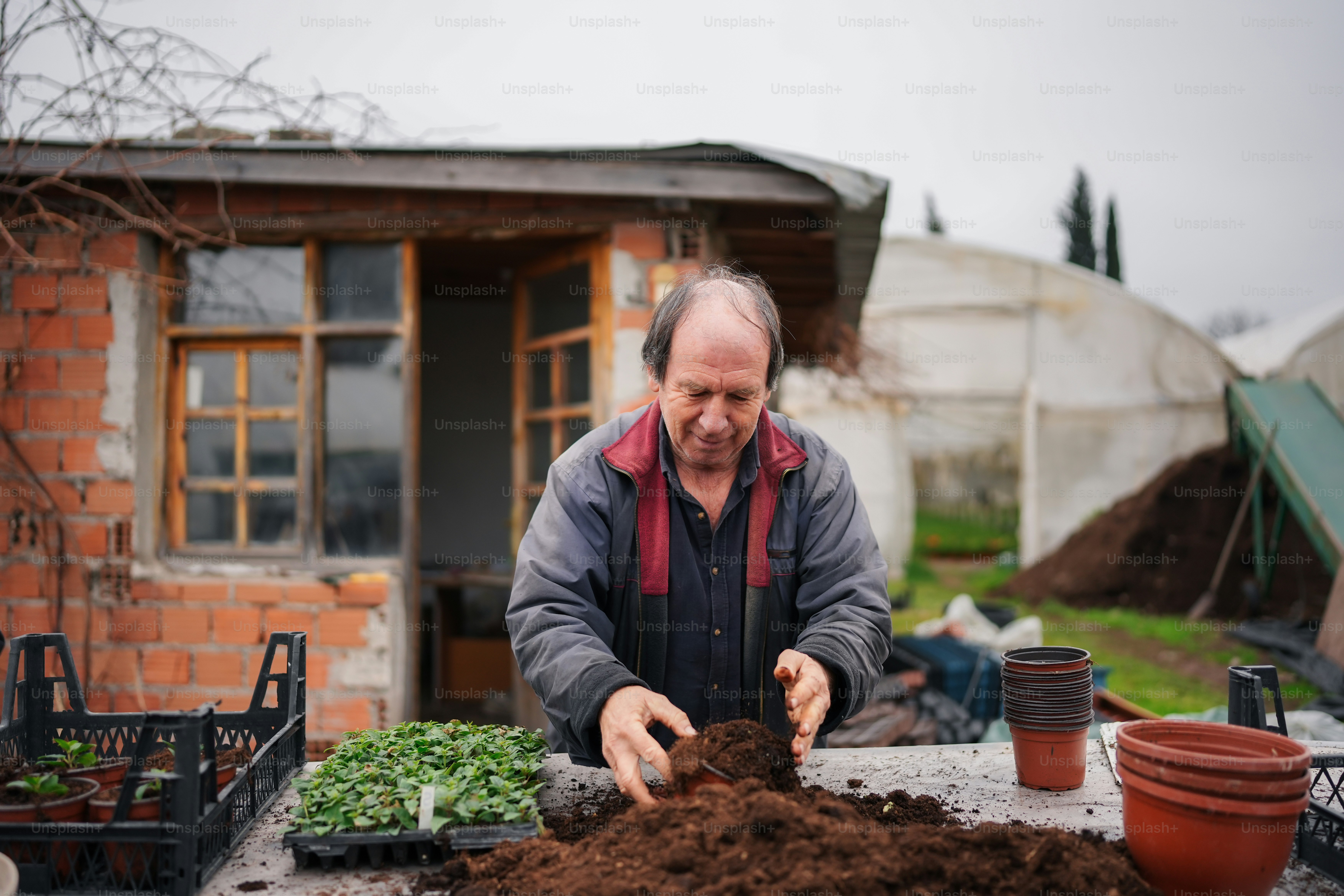 a man that is standing in front of a pile of dirt