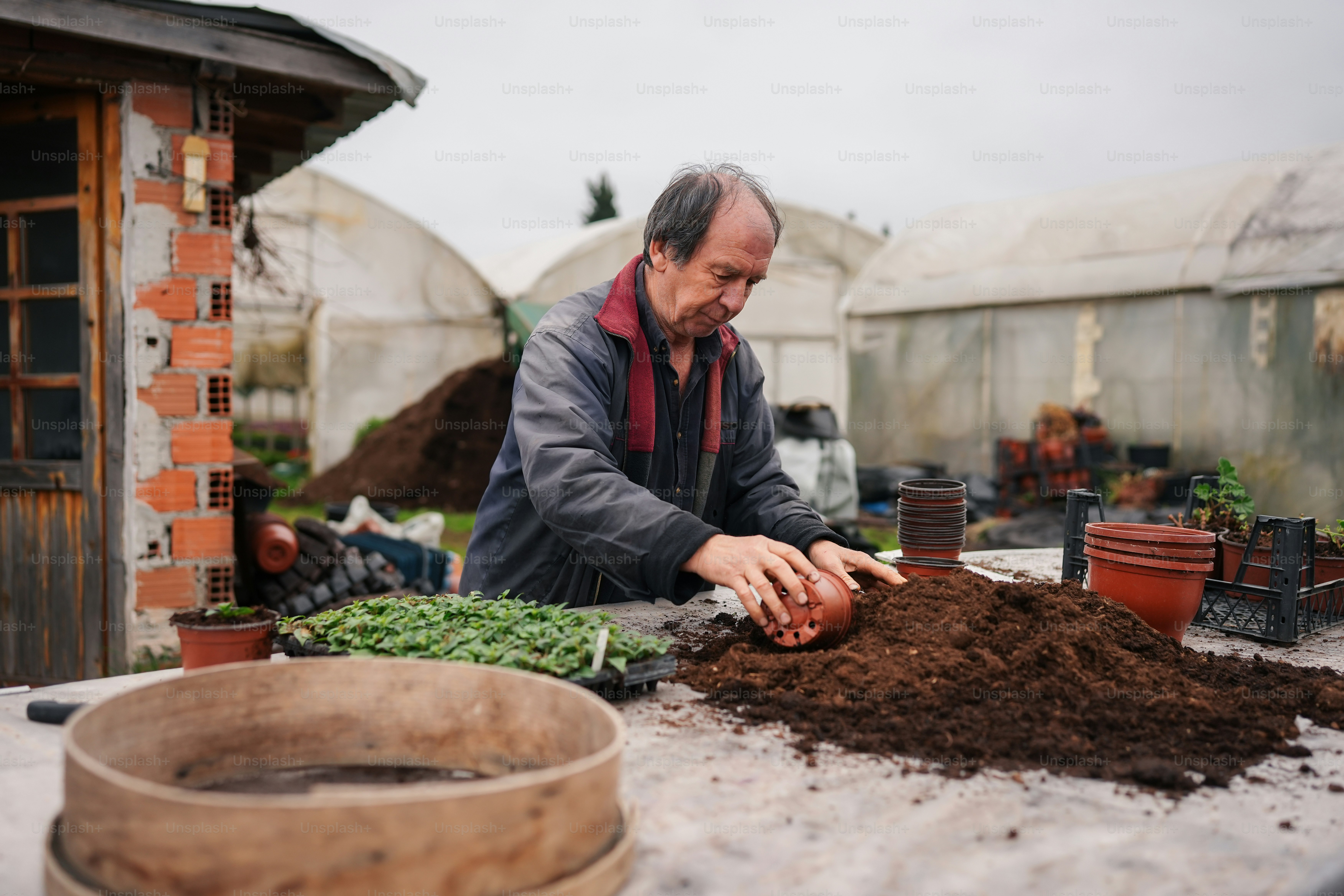 a man that is standing over a pile of dirt