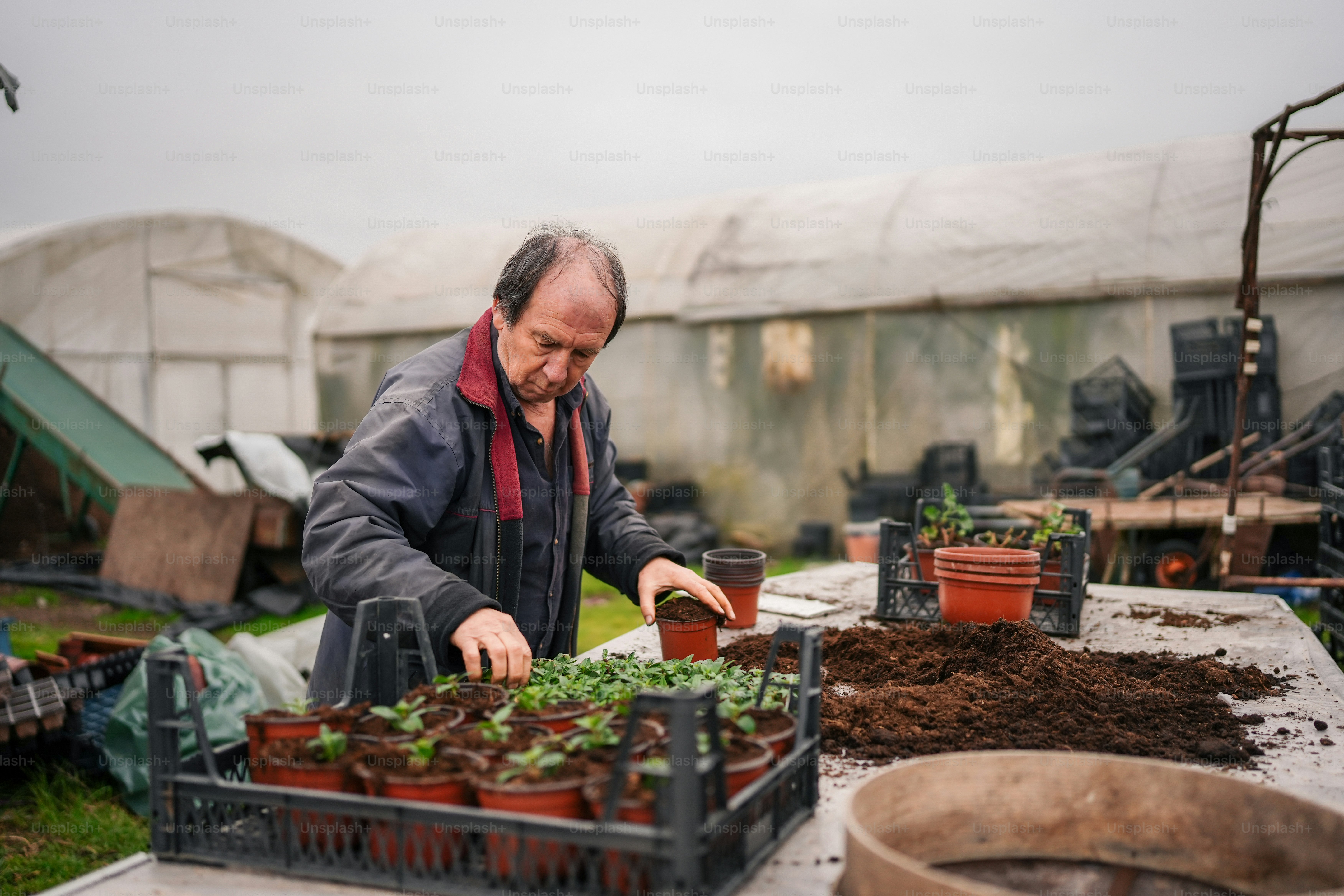 Man with a load of plant pots