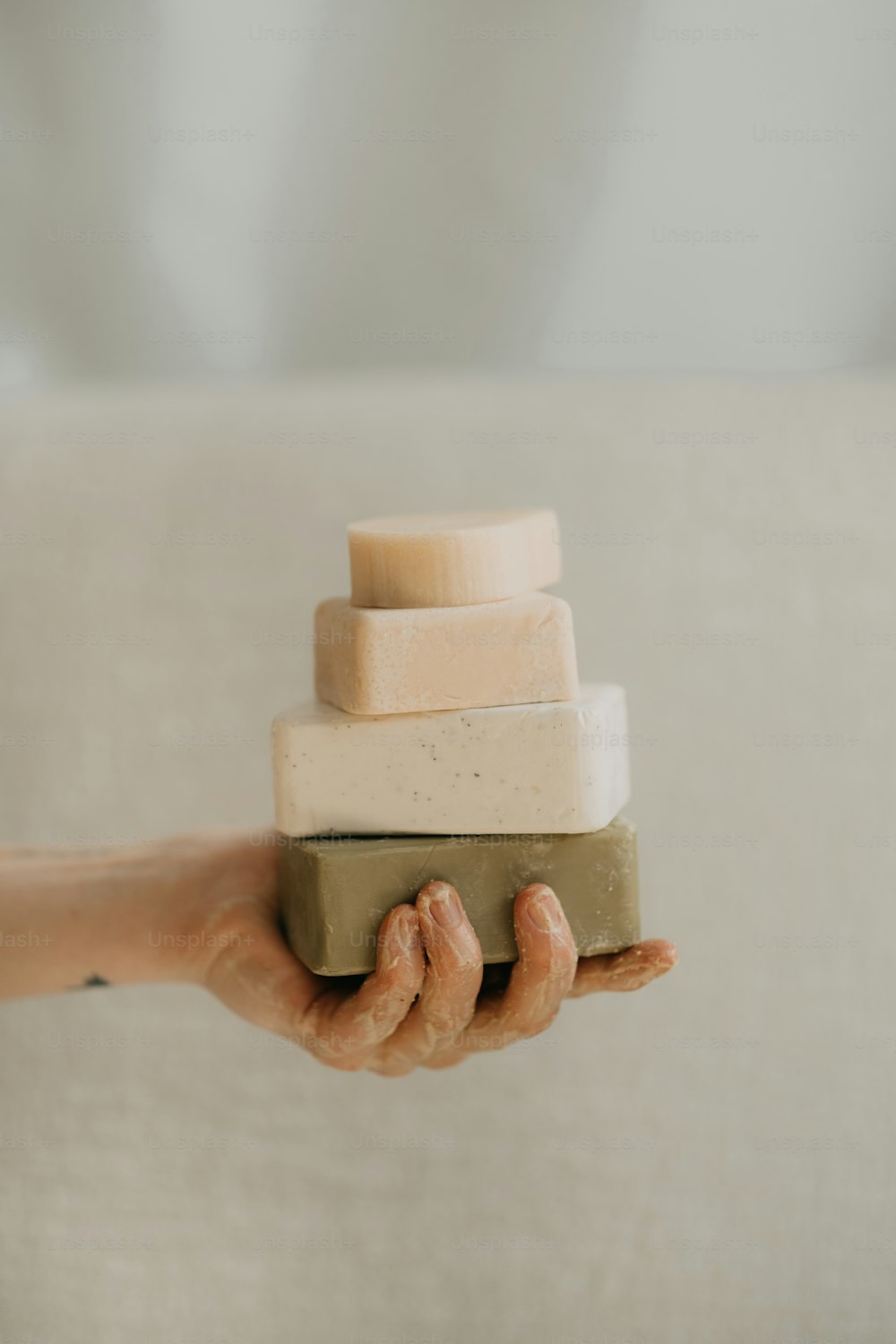 a person holding a block of soap in their hand