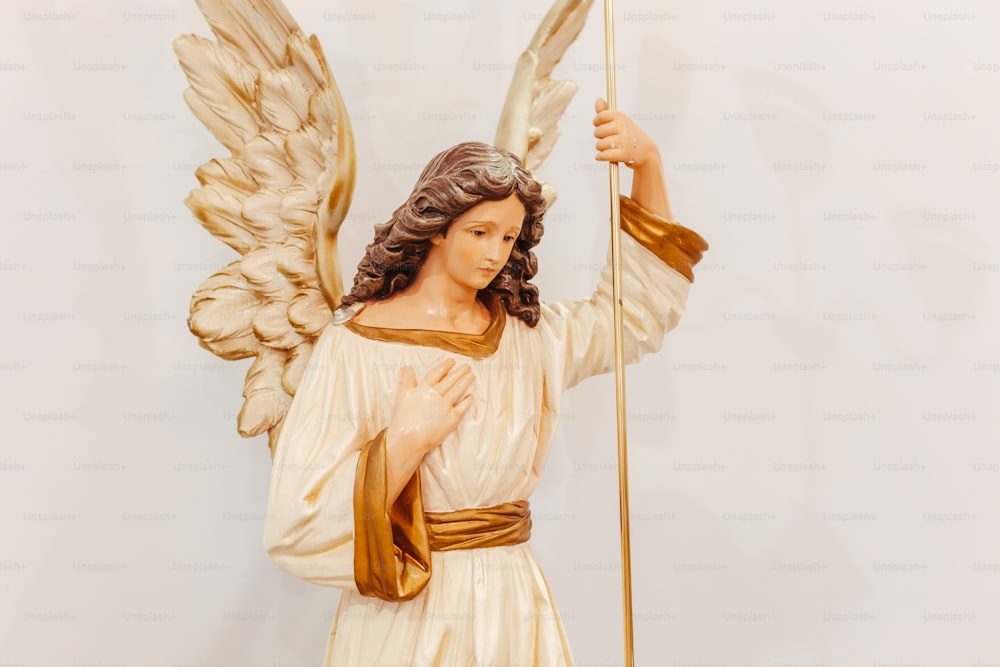 a statue of an angel holding a staff