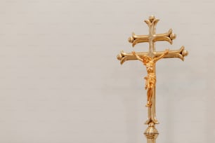 a golden crucifix on a white background