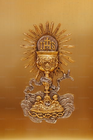 a golden statue with a cross on top of it