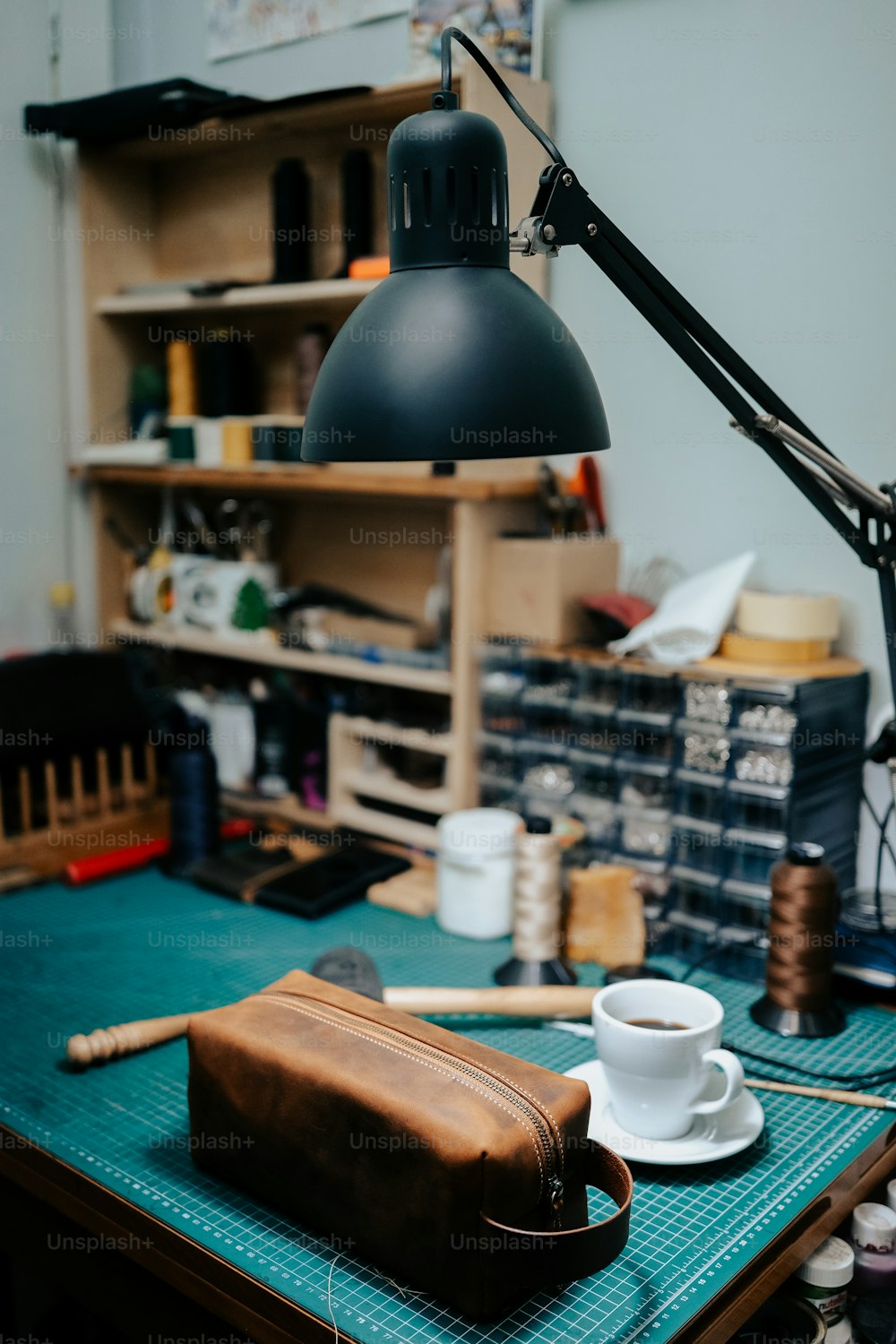 a brown bag sitting on top of a table next to a lamp