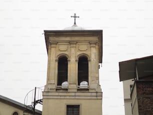 ein hoher Turm mit einem Kreuz darauf