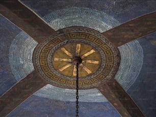 the ceiling of a building with a clock on it