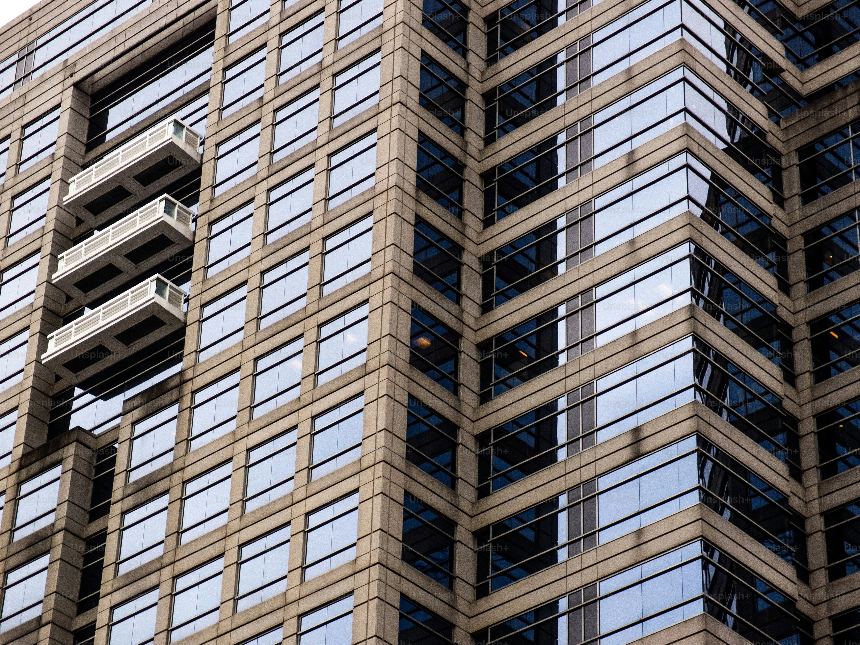 A very tall building with lots of windows photo – High rise Image on ...
