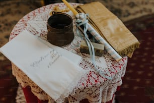 a table topped with a table cloth and a cup