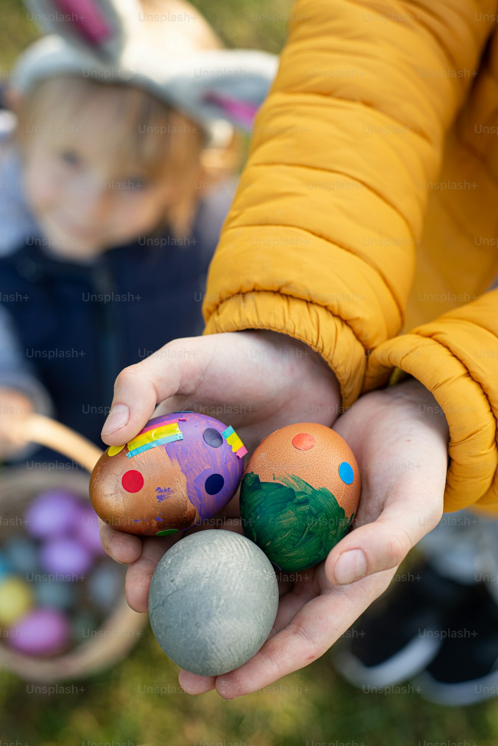 a person holding three eggs in their hands