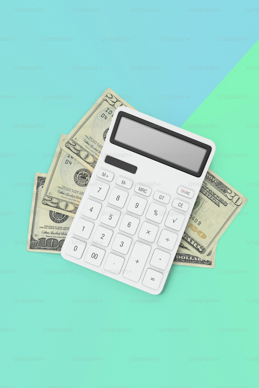 a calculator sitting on top of a pile of money
