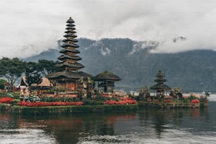 a group of pagodas sitting on top of a body of water