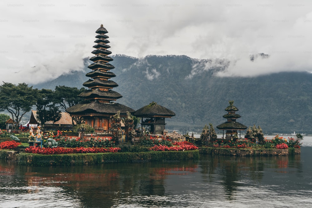 a group of pagodas sitting on top of a body of water