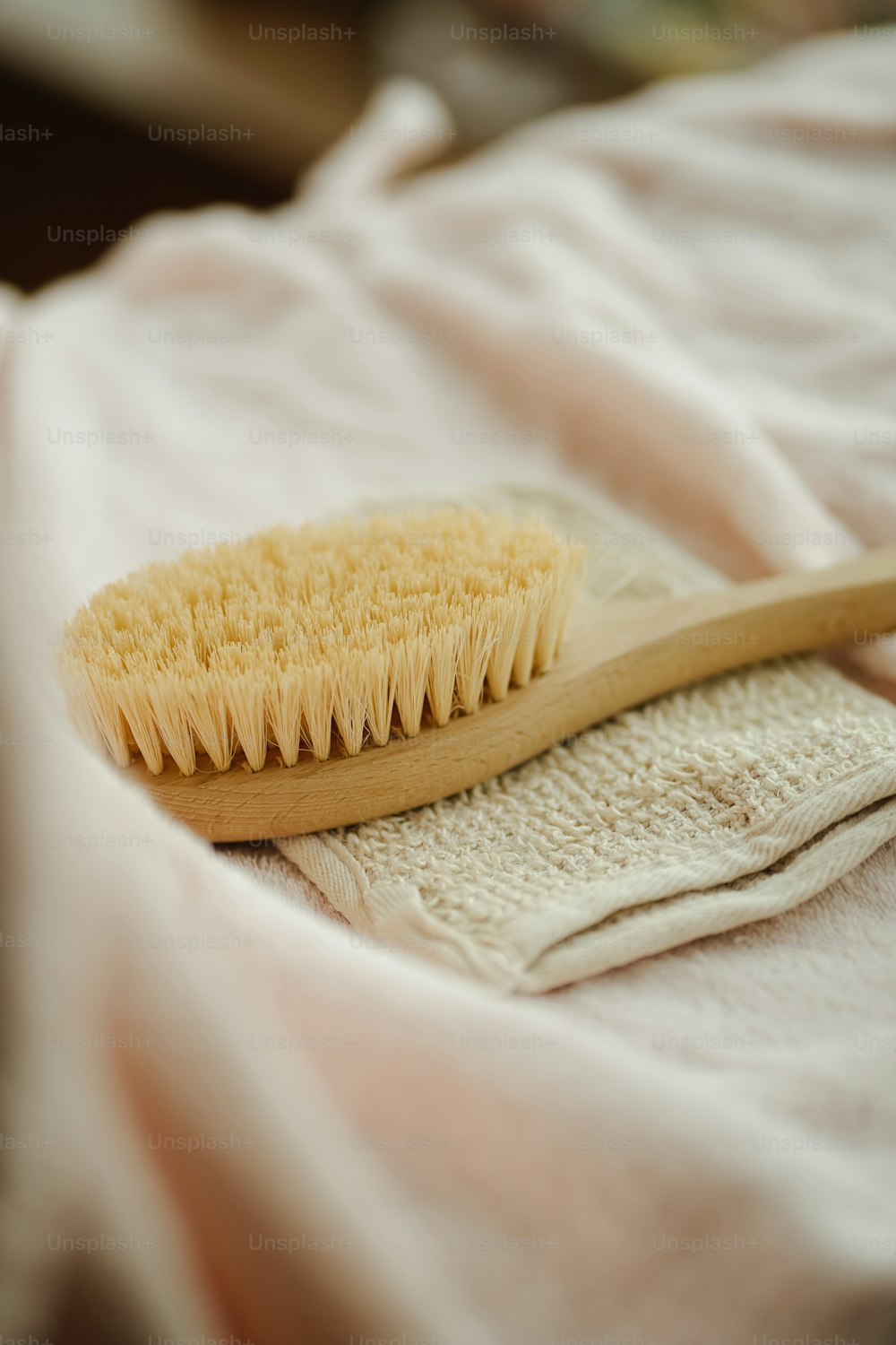 a wooden brush sitting on top of a white cloth