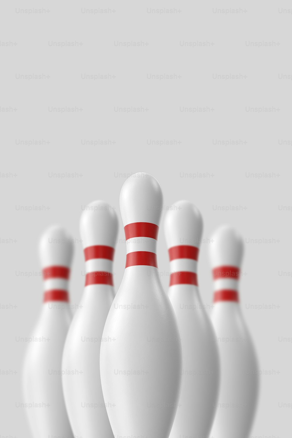a group of white bowling pins with red pins