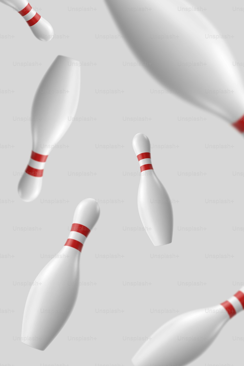 a group of white bowling pins flying through the air