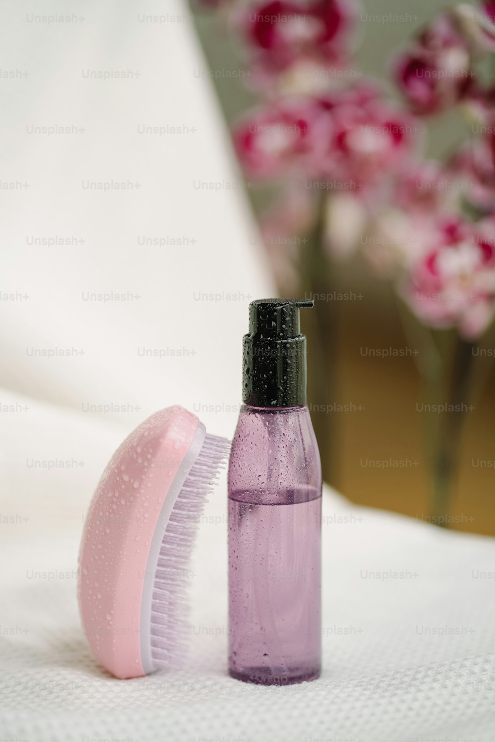a bottle and a brush sitting on a table