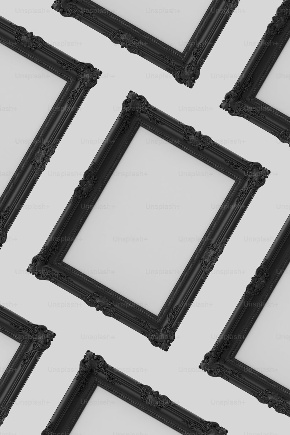 a group of black frames sitting on top of a white wall
