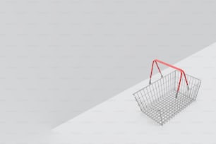a shopping basket with a red handle on a white surface