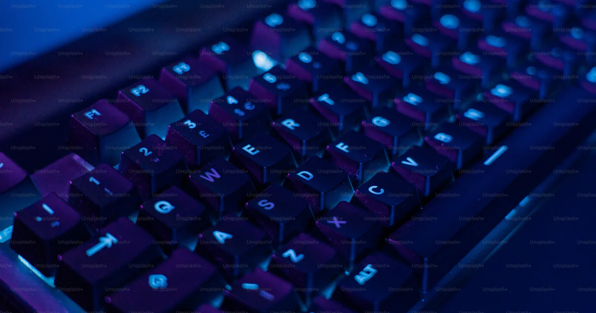A close up of a keyboard with a blue background photo – Gaming keyboard ...