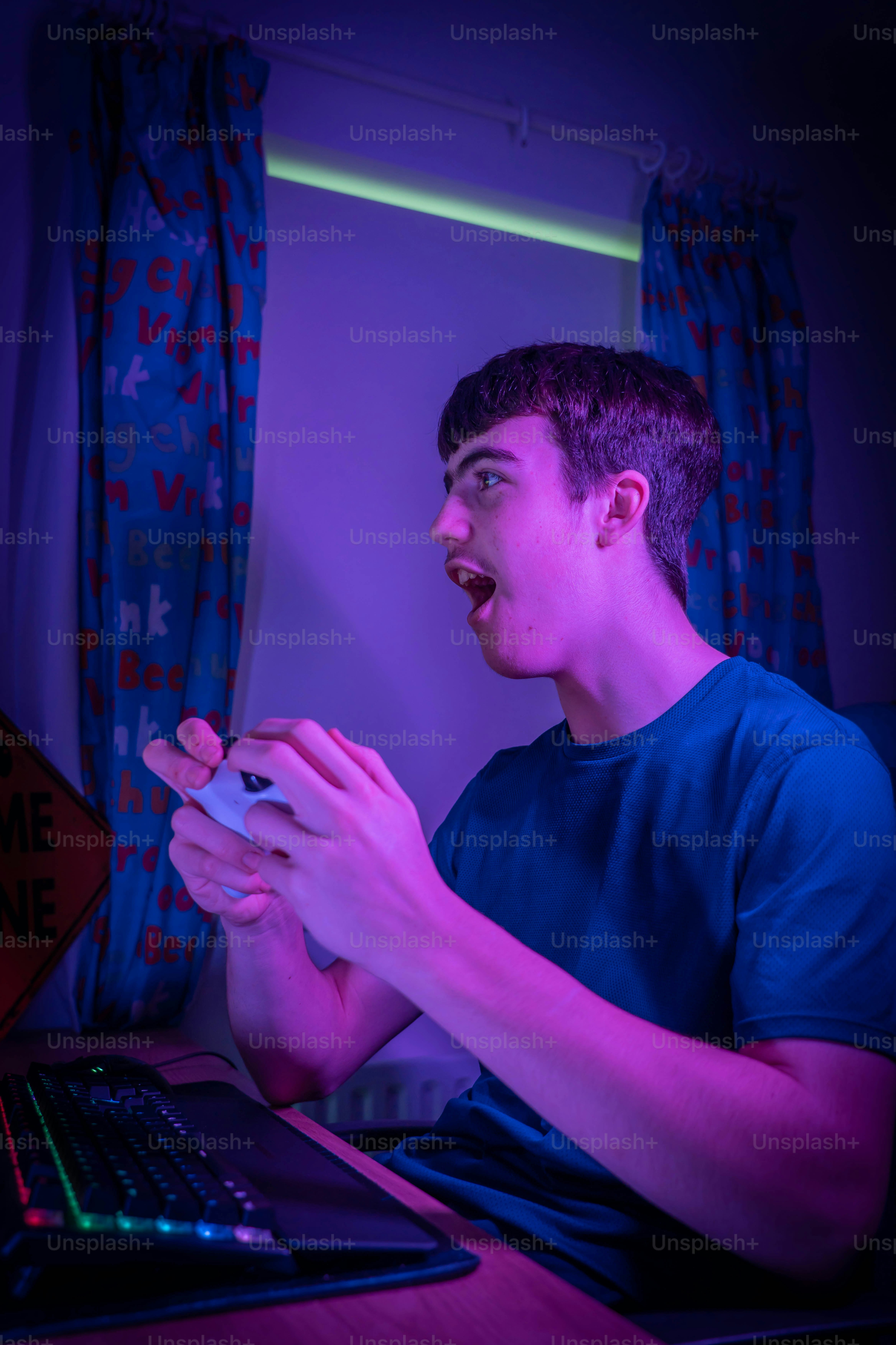 a young man sitting in front of a laptop computer