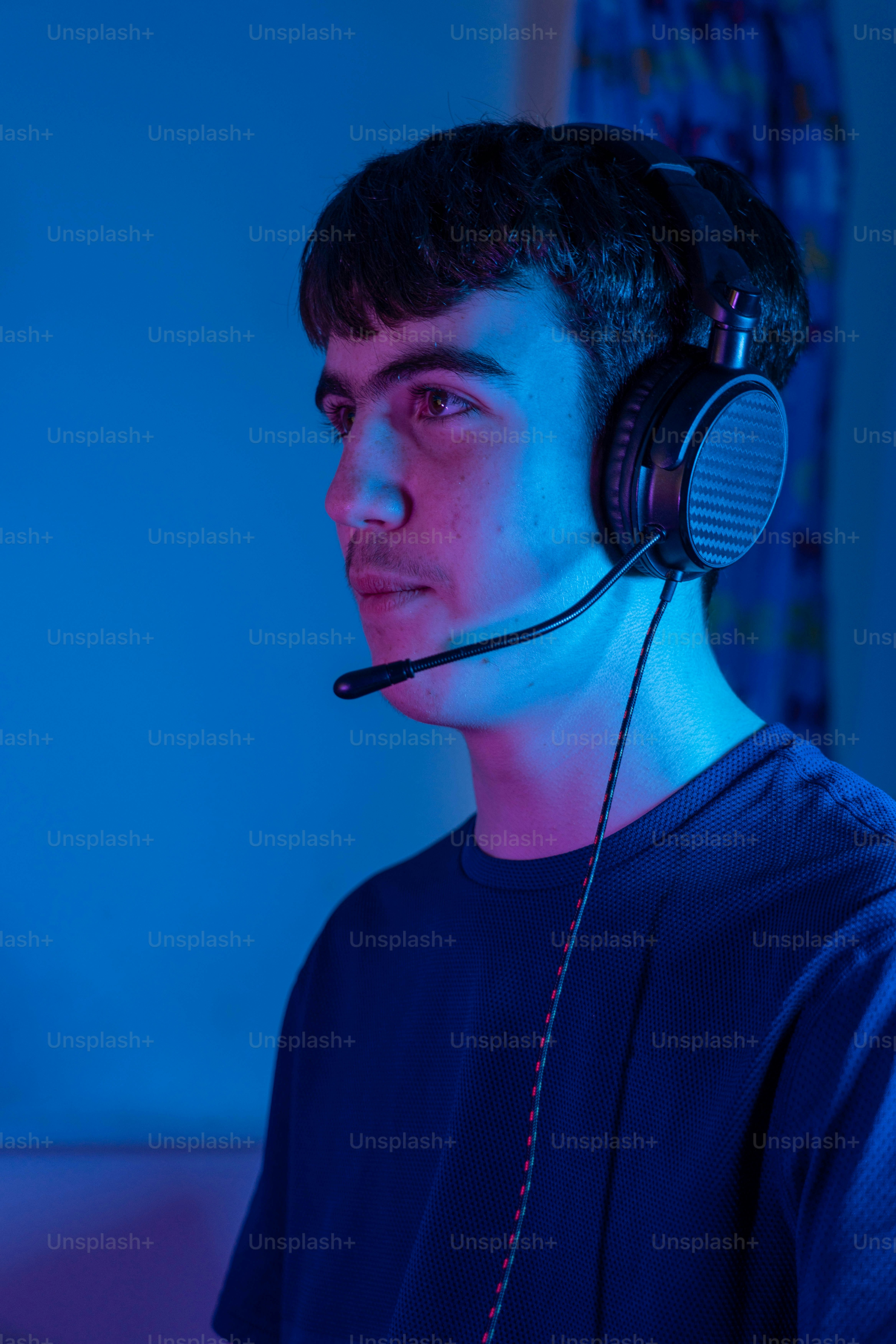 a man wearing a headset in a dark room