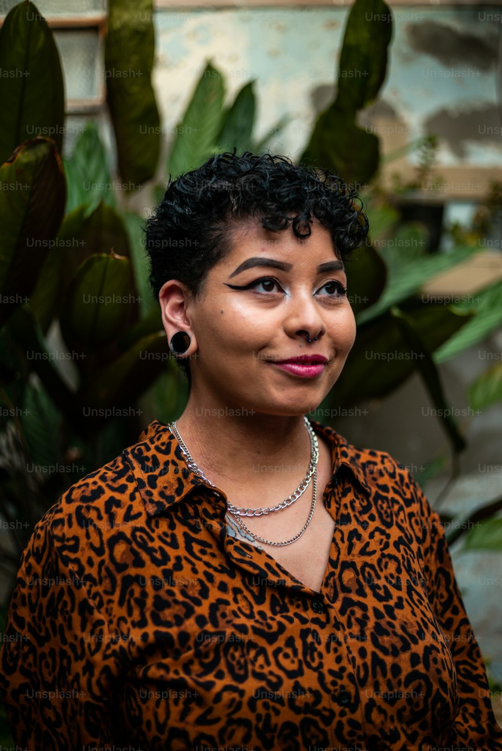 a woman wearing a leopard print shirt and a necklace