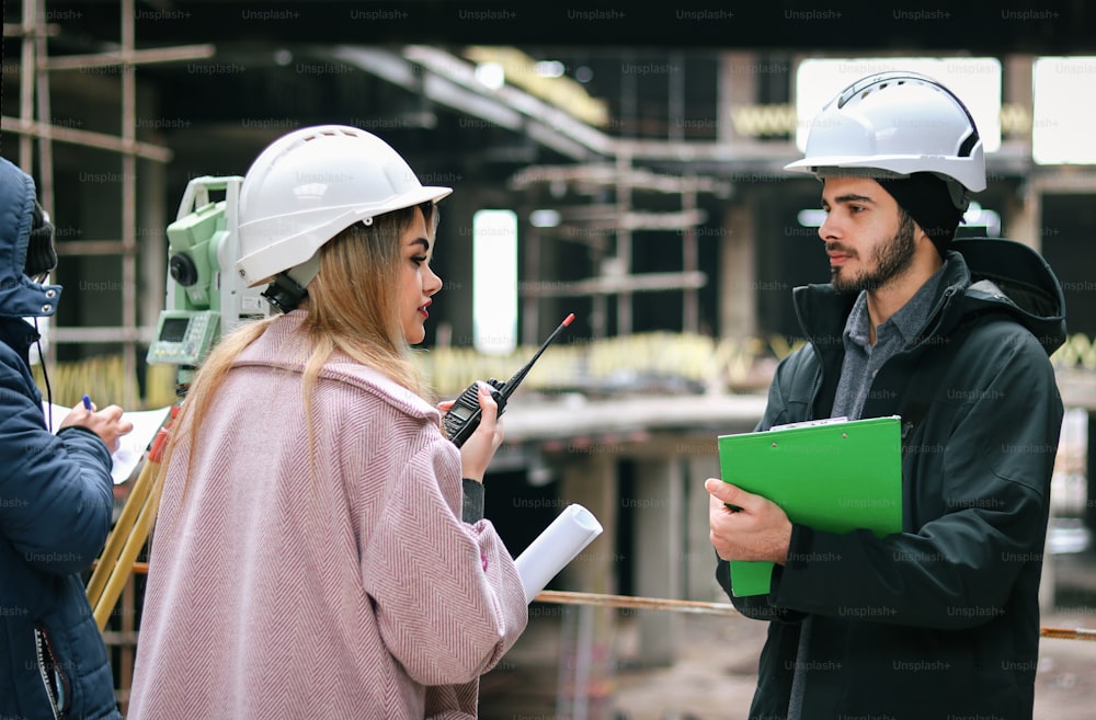 a man and woman in hardhats talking to each other