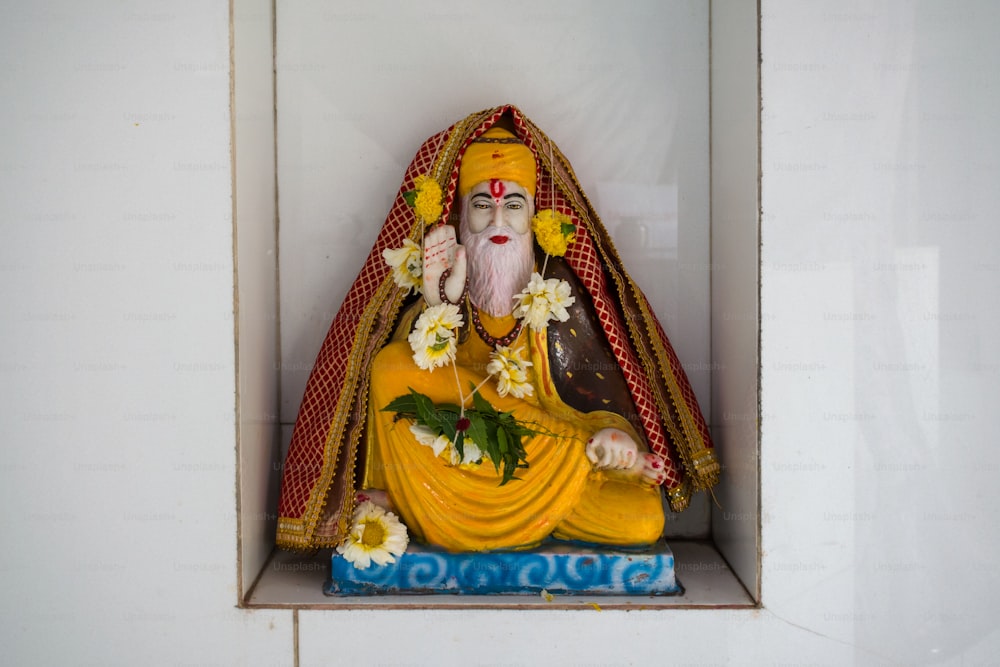 a statue of a man in a yellow outfit