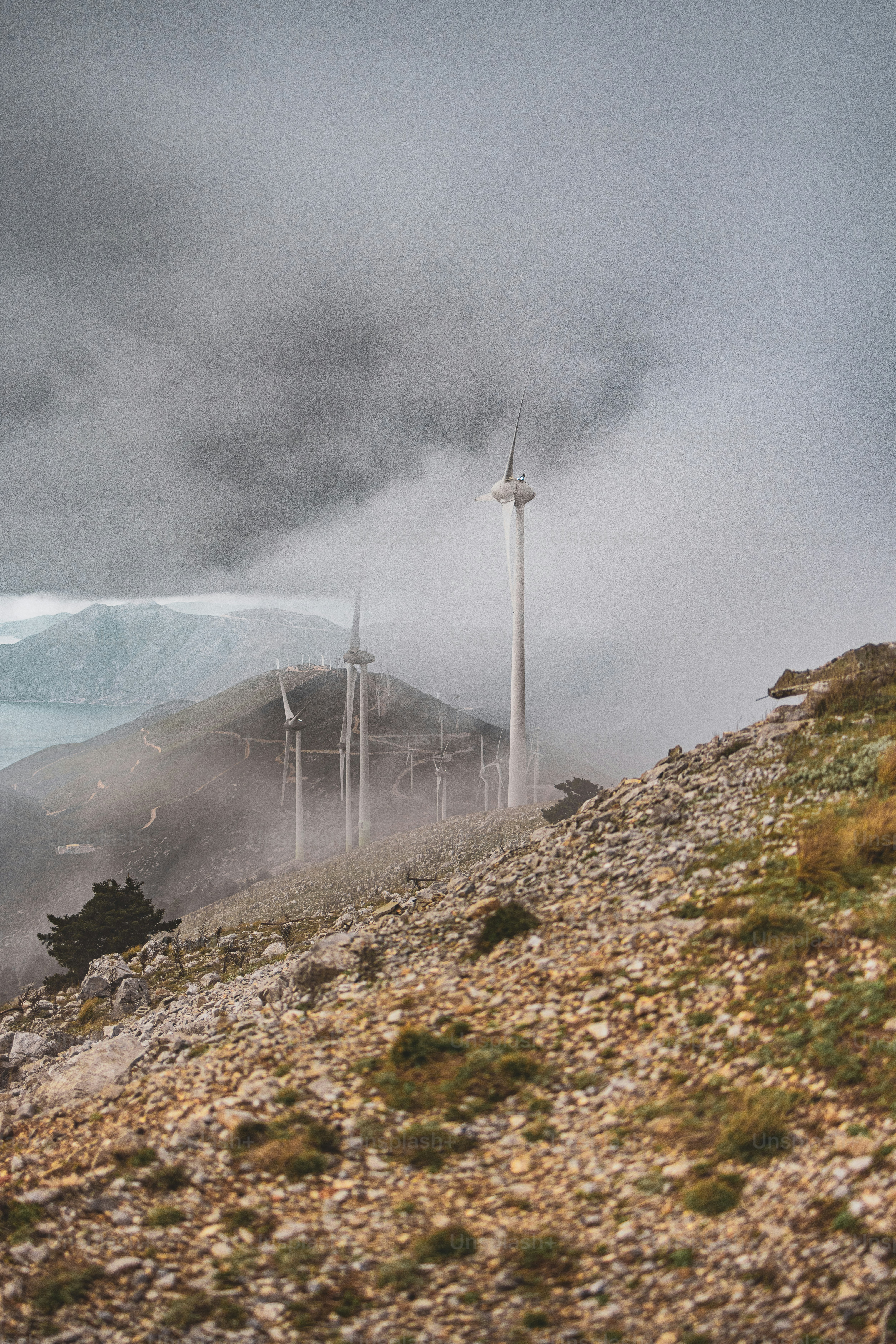 a group of wind turbines on top of a hill
