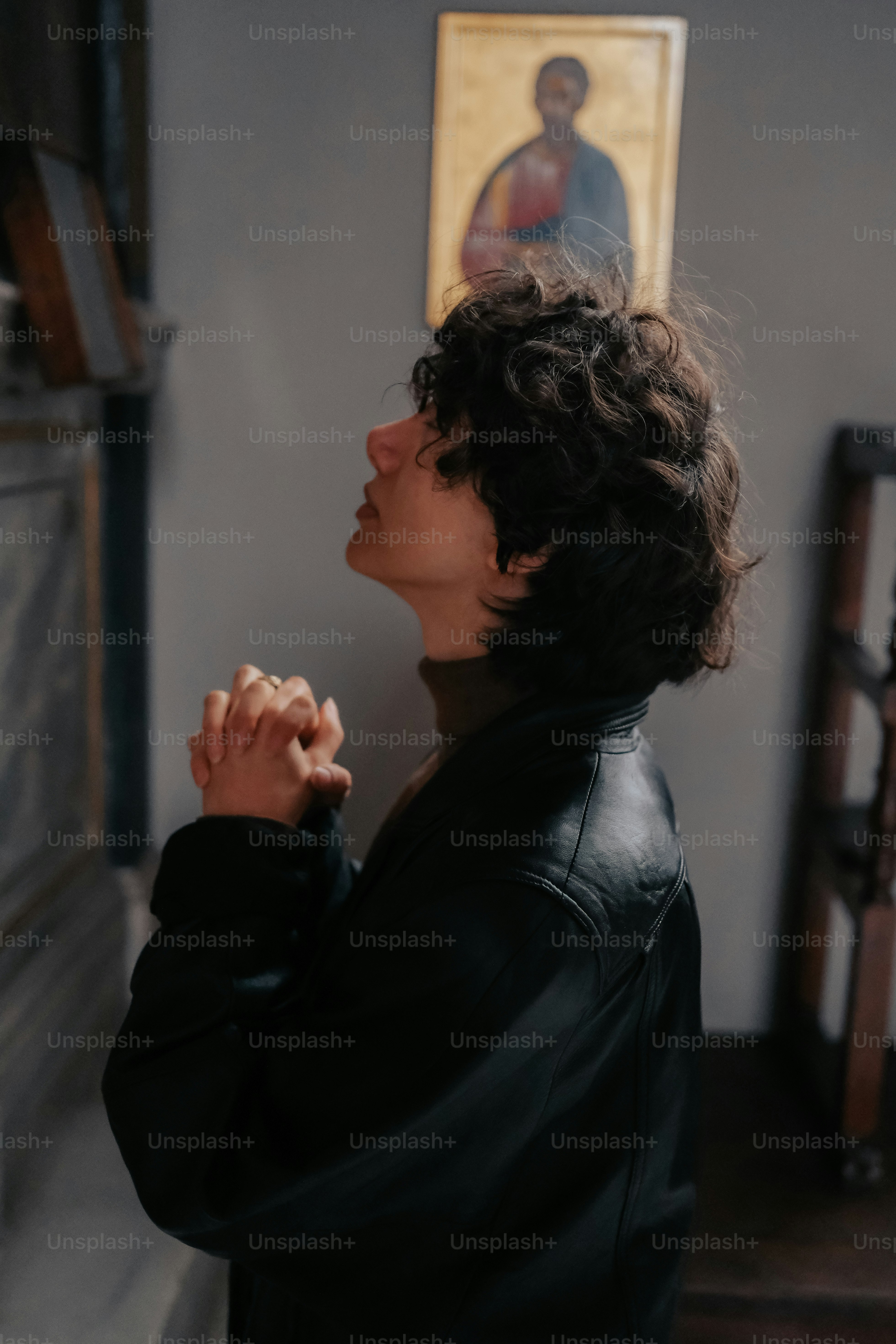 a woman standing in front of a painting