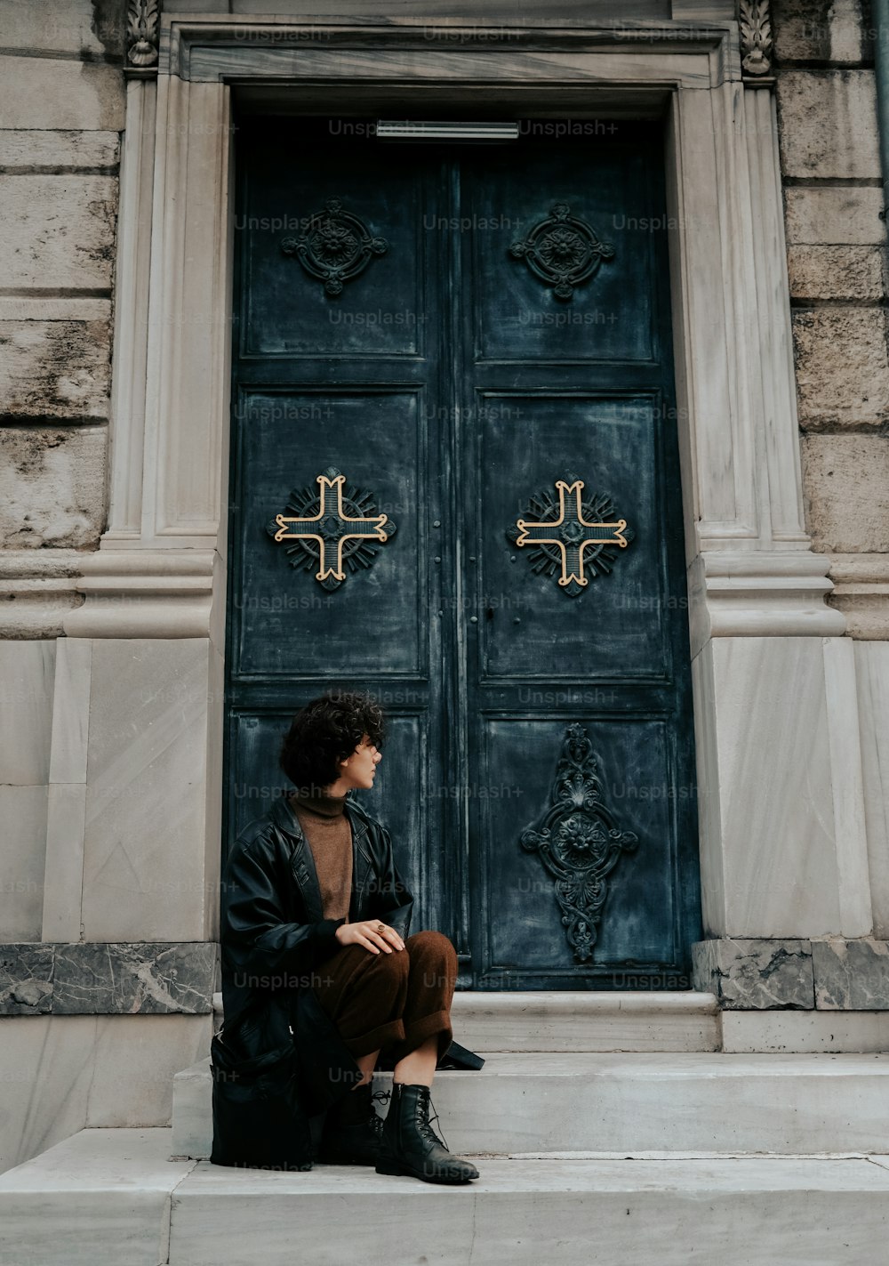 a man sitting on the steps of a building