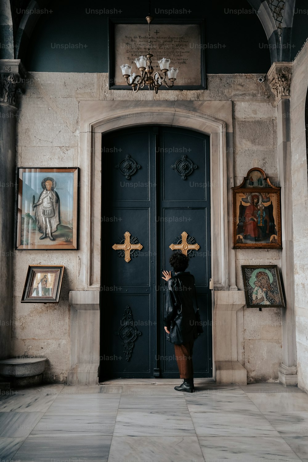 a woman standing in front of a blue door