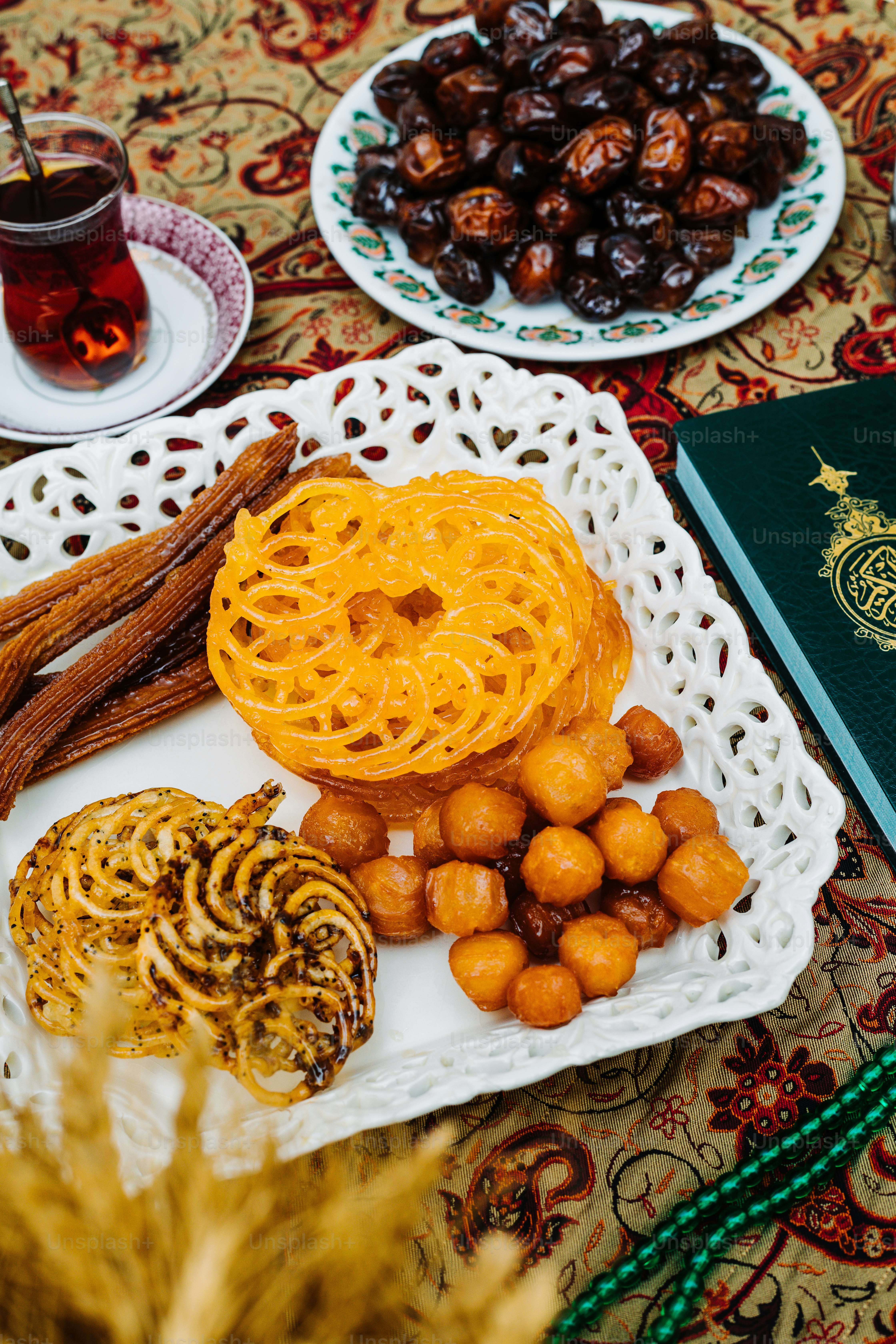 a table topped with plates of food and a book