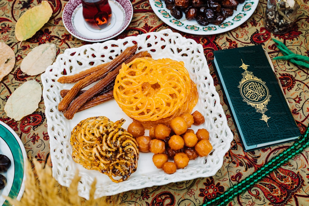 a table topped with plates of food and a book